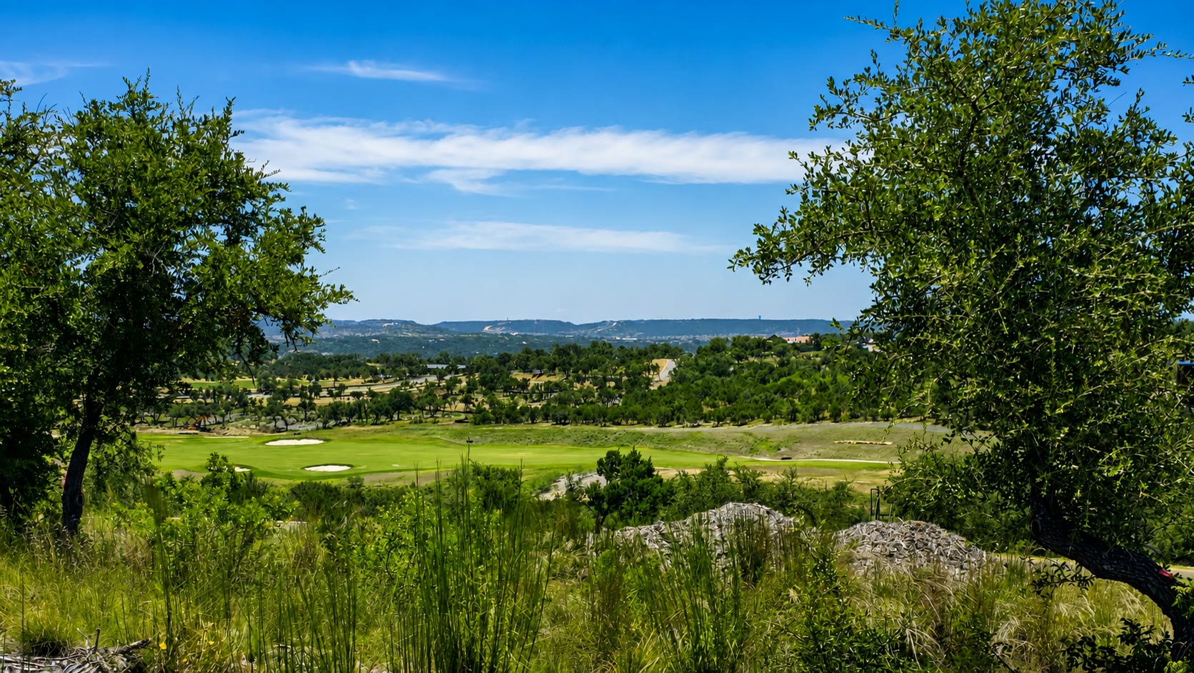 Golf and Hill Country outlook looking left from homesite 198 at Travis Club